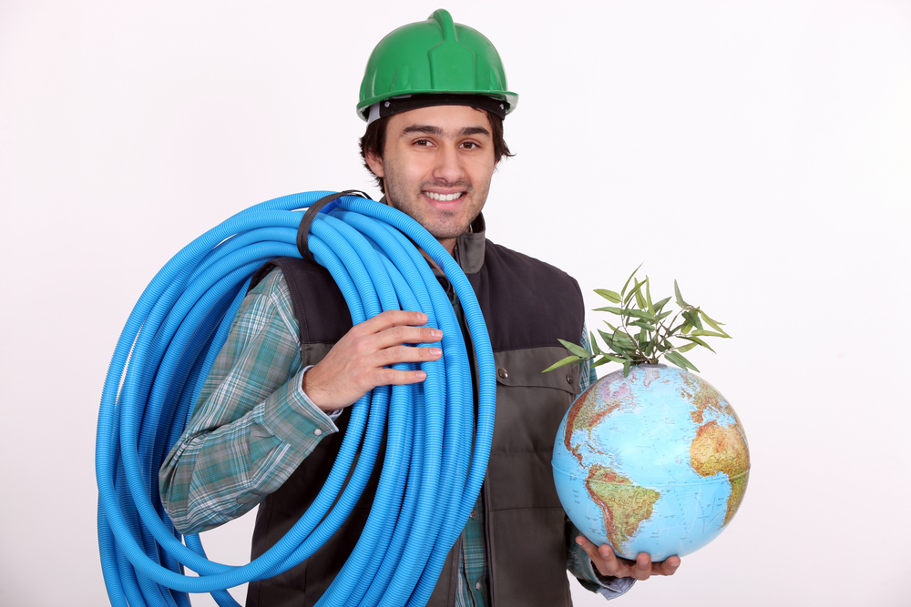 Construction Worker Holding Corrugated Tubing and a Globe